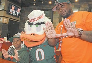 Serious UM fans Dream Grimes with his father Theo Grimes and Sebastian.