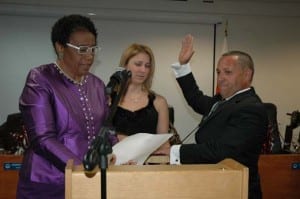 Opa-locka Commissioner Luis B. Santiago, sworn-in by District One Miami Dade County Commissionber Barbara Jordan as family member Gisela Correa proudly watches.