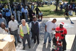 Commissioner Timothy Holmes and the City staff begin preparing todistributed the Turkeys