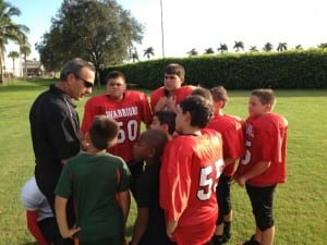 Coach Tommy Valentine huddles DCS “Warriors” elementary team.