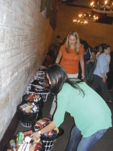 Dozens of Thanksgiving baskets lined up here are being filled to the brim for needy families by members of the GFWC Coral Gables Woman’s Club.