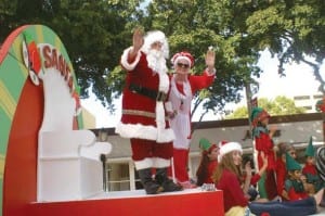 As Santa and Mrs. Claus are cruising around town,they find themselveswaving at all the local bystanders.