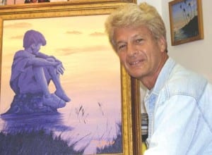 Artist David Schor is pictured with his painting, Boy on the Rock.