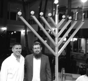 Vice Mayor Josh Leibman (left) joined event organizer Rabbi Levi Friedman and lit the 9-foot-high Menorah