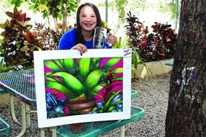 Abbey Franklin is pictured with her prize-winning artworkand trophy in the patio at Southwood Middle School.