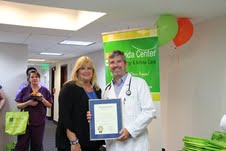 Maria Machado, Miami-Dade County Mayor's aide, and Dr. Frank J. Martell with the proclamation.