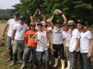 Students taking part in Belen Jesuit’s 2013 Belen Youth Mission Trip pose for a picture while holding building tools.