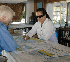 Pam Andersen (right) explains the intricacies of the waters around Plantation Key to Ronald Shelley.