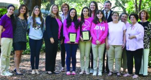 Cathy McCarthy, executive director for the Susan G. Komen Miami/Fort Lauderdale Affiliate, presented Student Activities director Elena de Villiers, head of Upper School Ashley Chapman, and parents and students with two plaques for High School Team with Most Participants and Top High School Fundraising Team during the 2013 Race for the Cure.