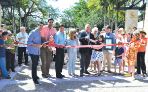 Pictured (l-r) are Commissioner Vince Lago, Commissioner Frank Quesada holding baby Mila Sofia Quesada, Vice Mayor Bill Kerdyk Jr., Carmen Cason, Mayor Jim Cason, former Mayor Dorothy Thomson, Doug Kellner and his children, and Commissioner Pat Keon holding her granddaughter Ella.