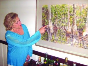 Faces hidden in forest attract Baron Estate Sales’ Fran Miller to this painting.