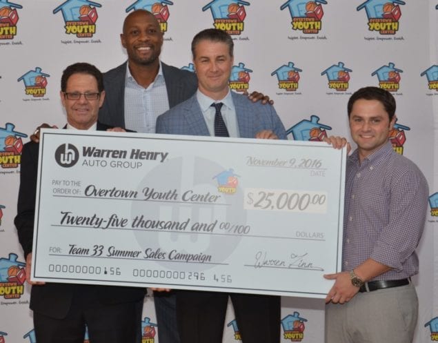 Warren Henry Auto Group presents check for $25,000 to Overtown Youth Center