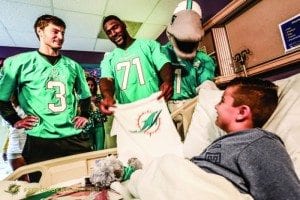 Dolphins spread holiday cheer at Baptist Children's Hospital