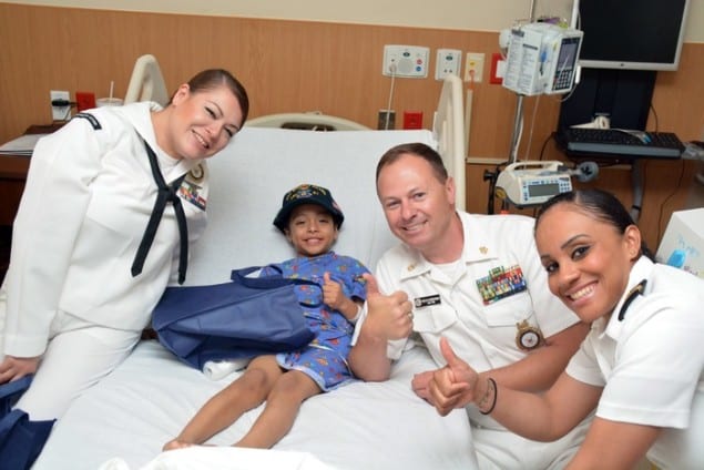 Members of U.S. Navy visit young hospital patient