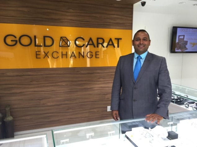 Luis Junco stands behind the display counter at Gold & Carat Exchange at The Falls, one three locations in the Kendall area.