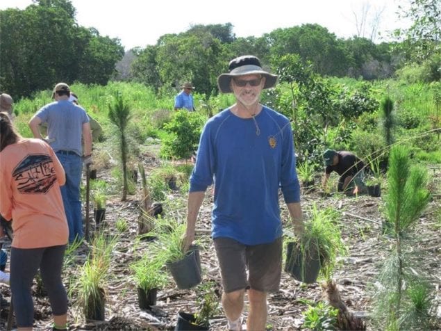 Volunteers pitch in to help clean wetland in restoration project