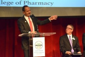 Chairman of Board of Larkin Heath Sciences Institute Jack J. Michel, MD, addressing the inaugural students of the College of Pharmacy, as Dean Gary M. Levin looks on.