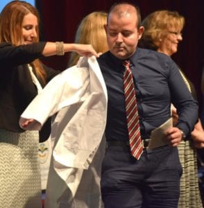 College of Pharmacy student Andrés A. Cancel dons his white coat for the first time, signifying the official launch of his studies with LHSI’s College of Pharmacy.