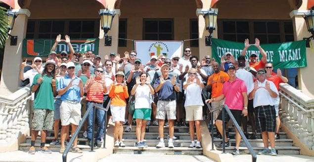 Canes golf players at a previous tournament proudly make the sign of “U” for UM.