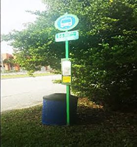 Bus stop at SW 47 Street and 157 Avenue has the barest of components- a pole and a trash can.