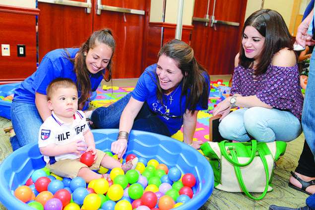 Lucas Santos, 13 months, enjoys the reunion festivities. He was born at 28 weeks of gestation and stayed in the NICU for two months.