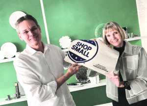 David and Marianne Russell strike a pose with a Small Business Saturday tote bag at Arango Design Store of South Miami.