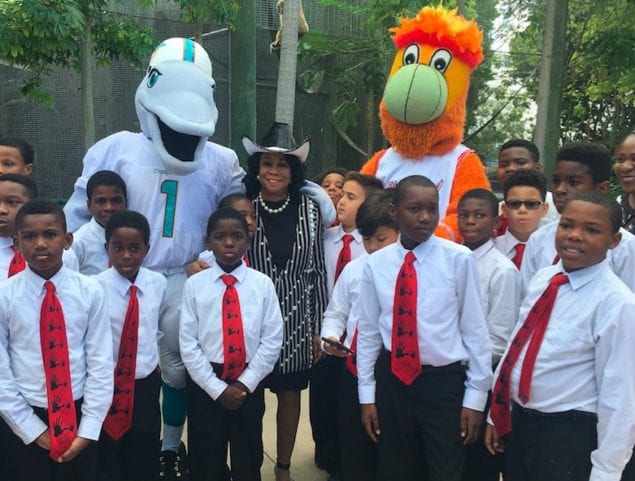 U.S. Rep. Frederica Wilson recently visited Jungle Island  to celebrate the achievements of an additional group of 500 students during 5000 Role Model’s annual holiday celebration. In this photo Rep. Wilson is joined by several “Role Model” students, as well as mascots “T.D.” from the Miami Dolphins and the Miami Heat’s “Burnie.”