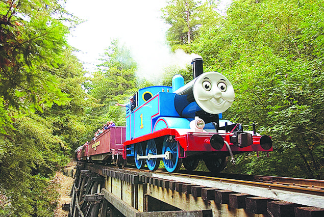 Thomas the Tank Engine is pictured rolling through the countryside.