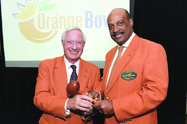 Michael Chavies, immediate past president and chair, (right) hands off the ceremonial gavel to Don Slesnick, newly installed president and chair.