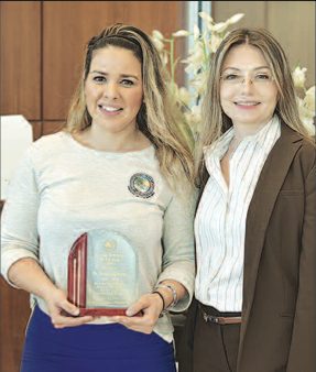 SIB Commissioner Larisa Svechin (right) presents the police award to Civilian Employee of the Year Norelli Liguori.