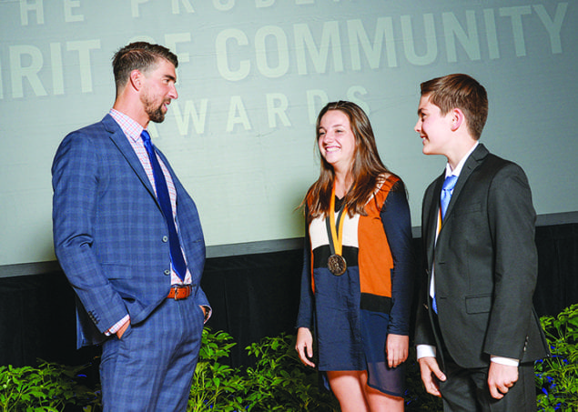 Student honored for volunteerism in ceremony with Michael Phelps