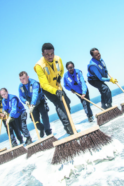 Miami sailor works to ensure carrier's flight deck is clean