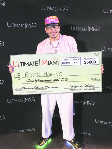 Roger Moreno accepts his check as Ultimate Miami Bartender 2016.