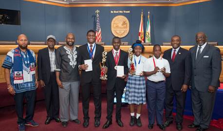 Commissioner Monestime congratulates the winners of the Sixth Annual Haitian History Bee. Pictured at left are Mecca Marcelin, Master of Ceremony, Ragaston Paul, Executive Director of SONS of Little Haiti, Prof. Jean Claude Exulien, Historian, Steeve Louis, Emmanuel Sanon from William H. Turner Technical Arts High School and Christina Fils, Armstrong Theophile from St. Mary’s Cathedral Middle School with Commissioner Jean Monestime, District 2 and Commissioner Dennis C. Moss, District 9. (Photo by Armando Rodriguez / Miami-Dade County)