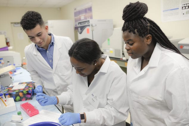 FSTAR fellows Donovan Valentin Torres, Kiara Norman and Lyse Louis in the HWCOM Immunology lab