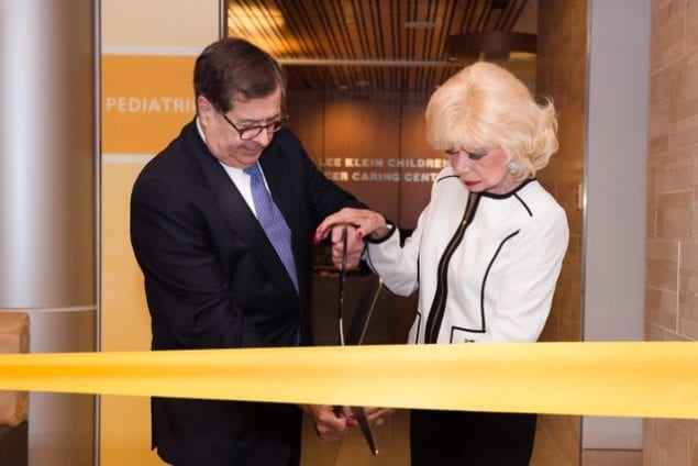 Children’s Cancer Caring Center Chairman CEO Lee Klein (right) cuts ribbon of new location with Dr. Michael Zinner (left) founding CEO executive medical director of Miami Cancer Institute.