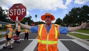 The presence of crossing guards encourages us to be mindful of student pedestrians.