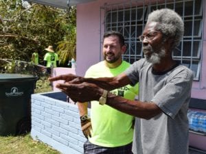 “Uncle Bobby” Holland points out to Campus Pastor Chris King where his old sea grape broke apart.