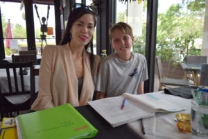 Holy Rosary St. Richard student J.J. Epstein and his mom Brenda squeeze a quick study session in between the spaghetti and meatballs on a Monday afternoon at La Mora.