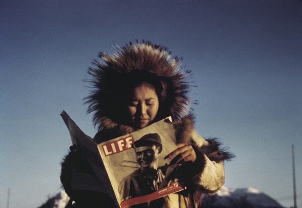 © Ruth Gruber: Eklutna woman reading Life Magazine, Hooper Bay, Alaska, 1941-43