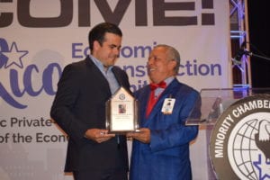 MCC President Doug Mayorga (l) honors Puerto Rico Governor Rosello at San Juan business summit.