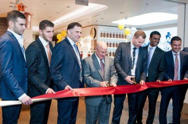 Miami-Dade Aviation Department Chief of Staff Joseph Napoli (center) cuts the ribbon with Duty Free Americas and Diageo Global Travel officials