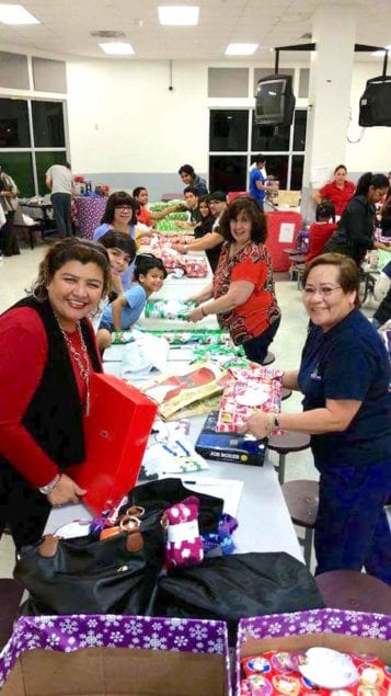 Volunteers at a wrapping party prepare gifts to be delivered to seniors throughout Miami. (Photo provided to Community Newspapers.)