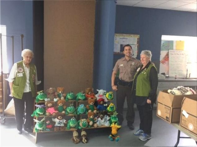 Club members Ann McAllister and Jane Ann Hotung are pictured with Officer Luis Sierra.