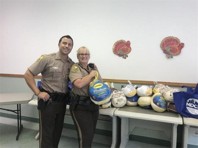 Families receive Thanksgiving meal from town policing unit