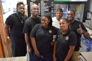 During a rare break in the action at Flavas with Owner-Operator Zacch Bell (back right) are staff members (l to r) Alex Davis, Carlton Silimon, Darrick Jones, (Zacch), and Tyra Carter.