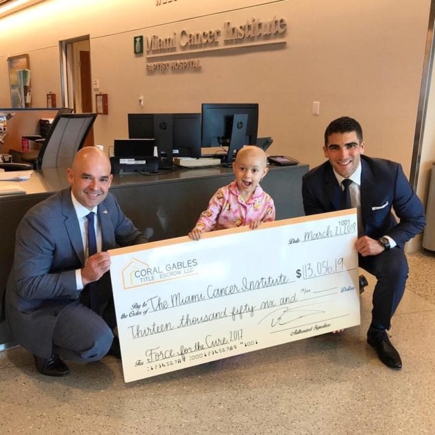 Coral Gables Title + Escrow presents donation to MCI