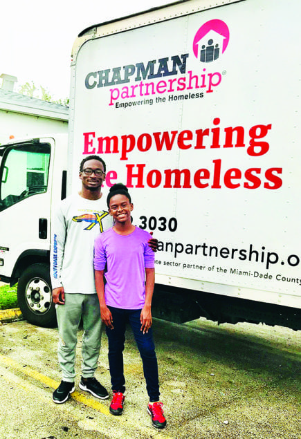 Amir Rasul Jr. helps Meara Rasul with her annual donation of various goods, clothing and shoes to the Chapman Partnership in Homestead.