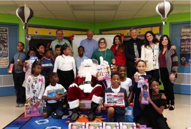 School Board member distributes toys to Colonial Drive Elementary students