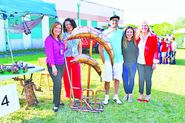 Village artist donates dolphin sculpture to Coral Reef Elem